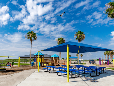 Shade Sails over a play ground in Panama City Beach commercial & residential outdoor spaces | We Can Shade It services Pensacola, Destin, Fort Walton Beach, 30a, Panama City Beach, Panama City, Mexico Beach, Tallahassee and all surrounding cities with Shade Sail Designs & Installation, Artifcial lawns & turf pads, sports netting, safety features & more.